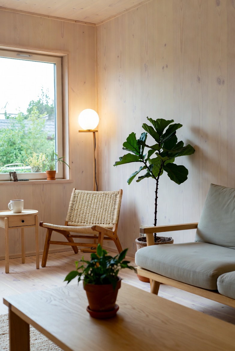 Living room corner with tall statement plant and cluster of table height greenery
